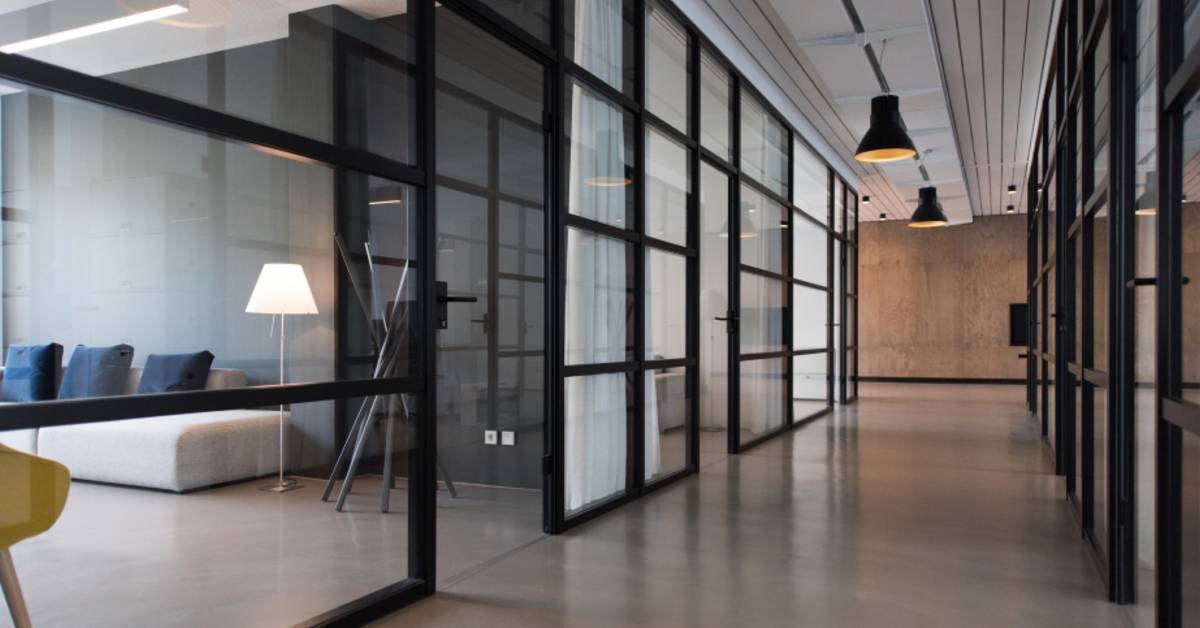 An image of an office building with glass walls and doors.