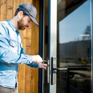 man fixing glass door