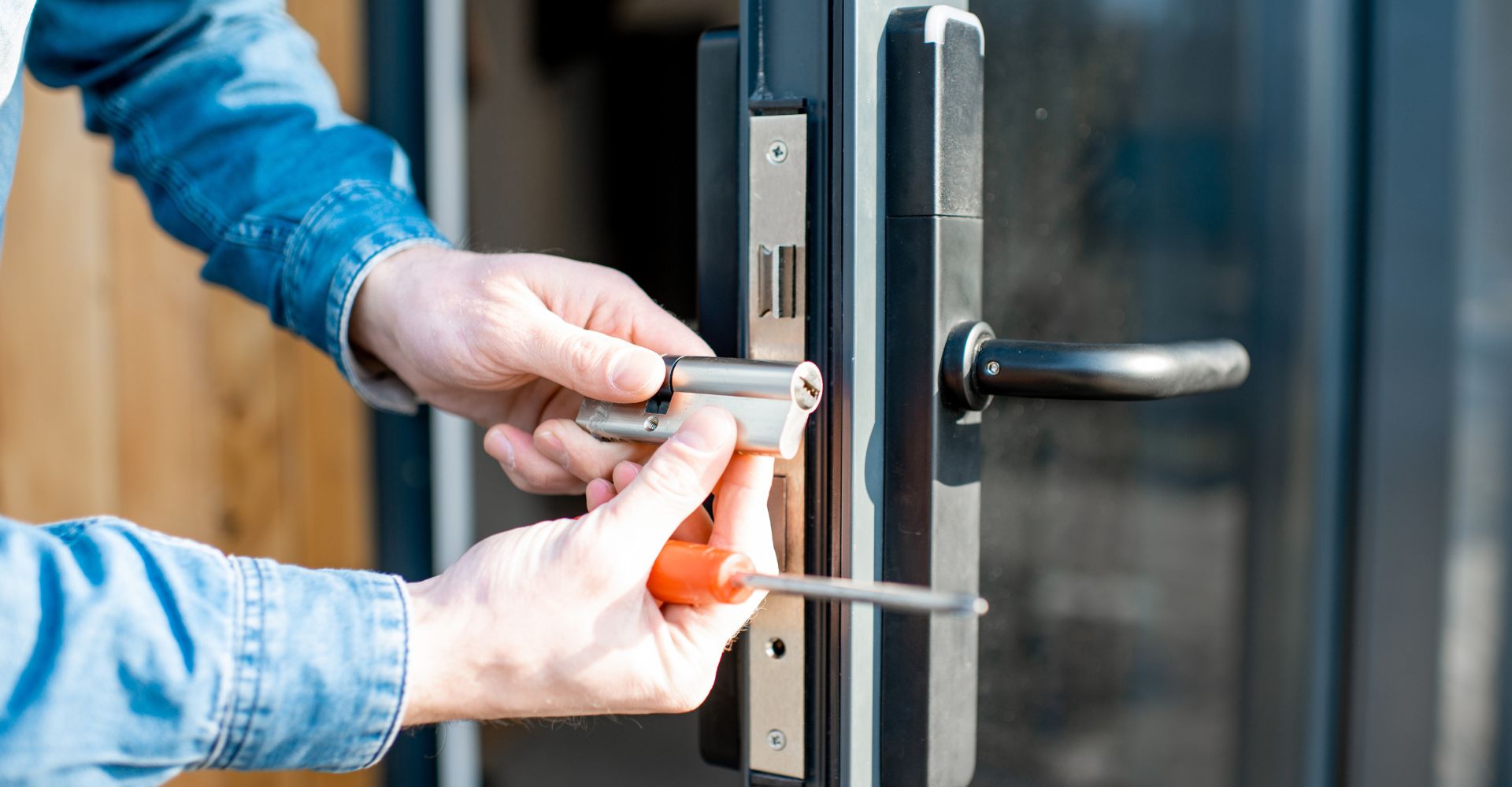 man holding lock near commercial glass door