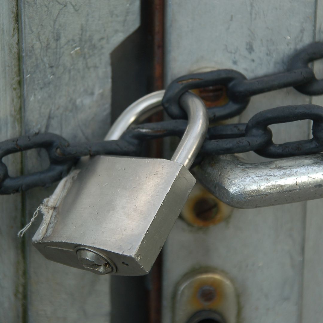 padlock and chain keeping door shut
