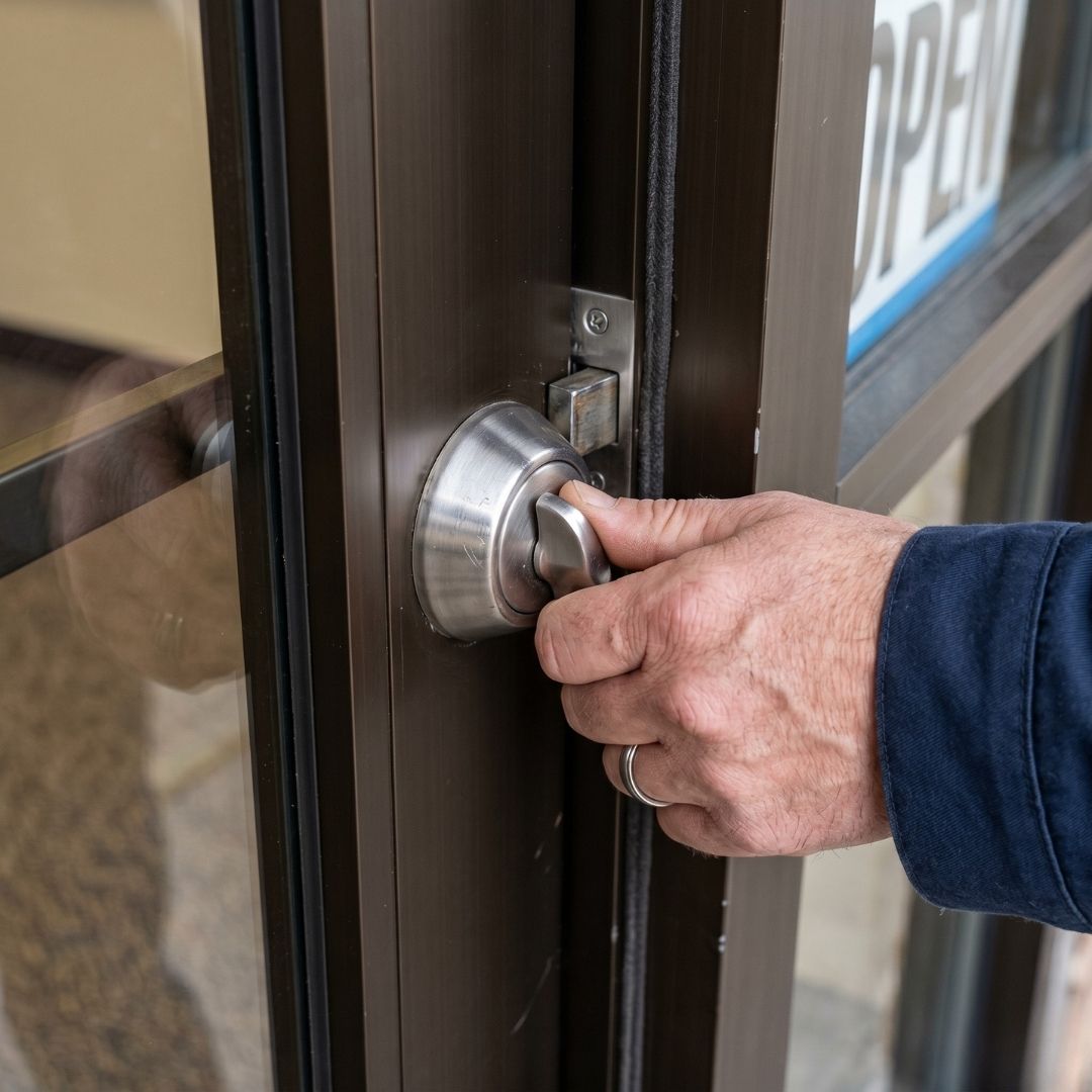an employee trying to lock a deadbolt