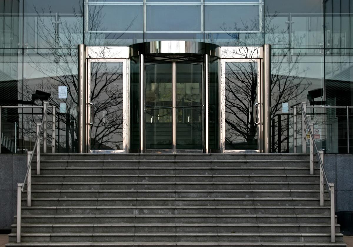 stairs up to a commercial building entry doors